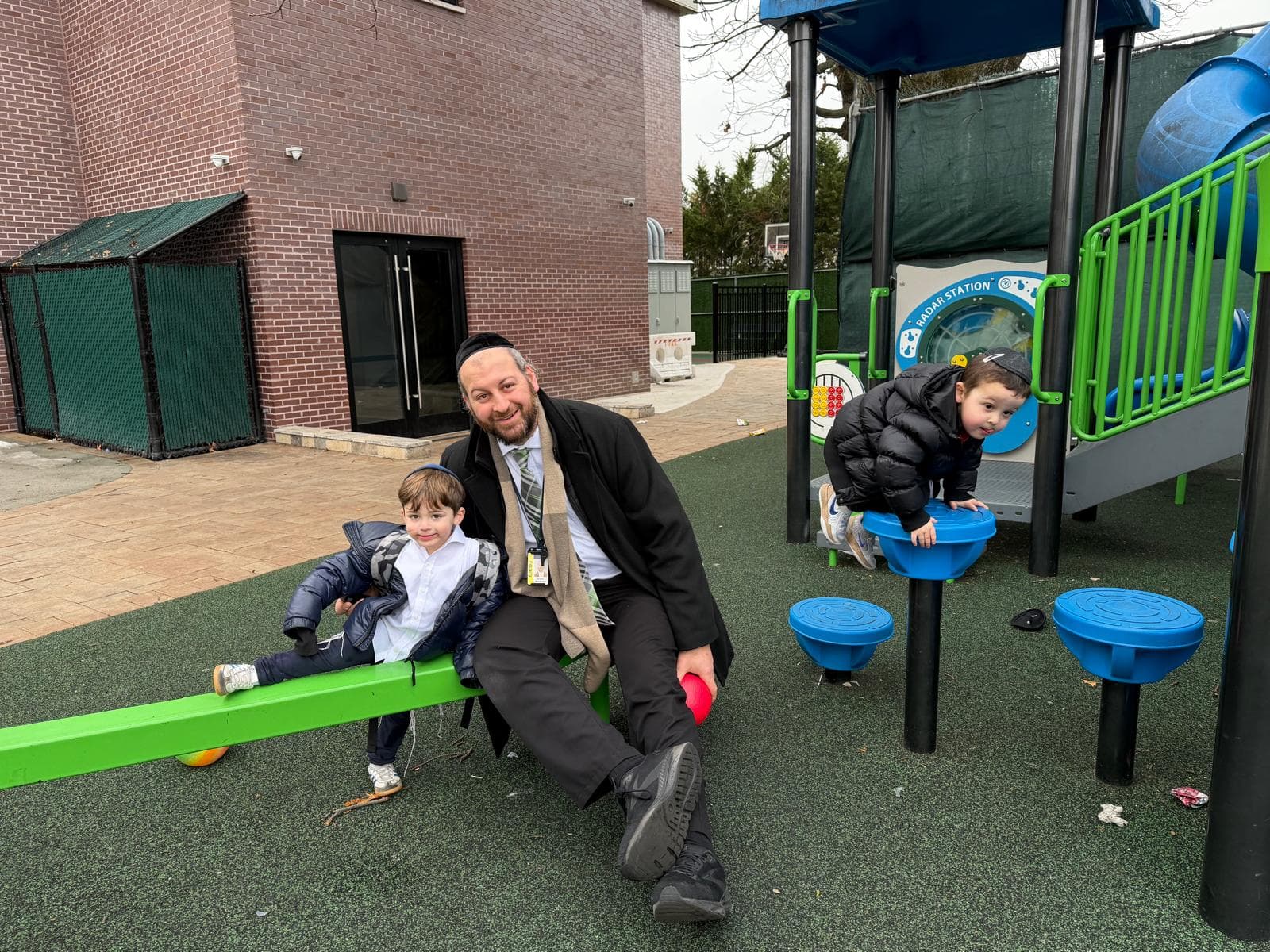 The youngest boys on the playground with a counselor