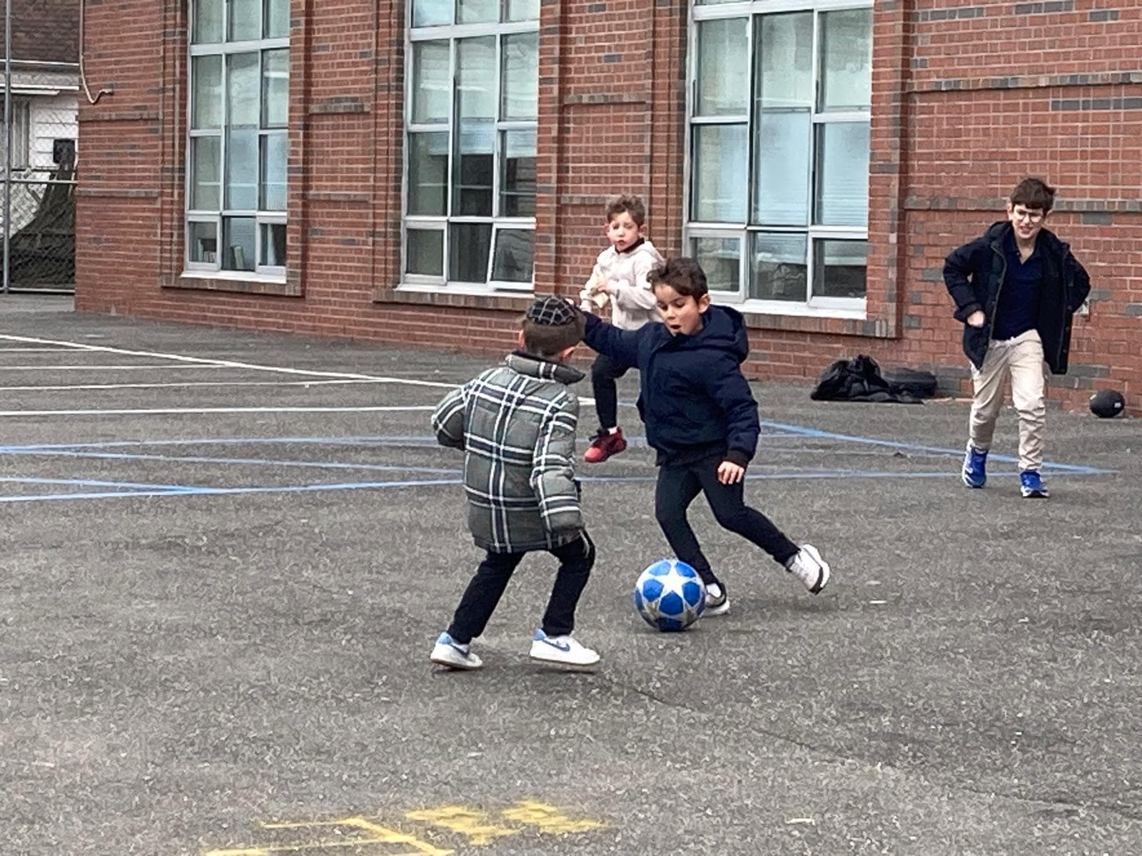 Two boys going for the same soccer ball